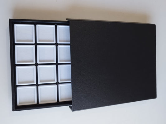 Black leather-style box with magnetic closure and sectioned interior. (23,5 * 19,5 * 3 cm)